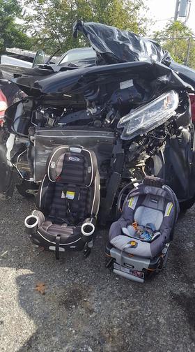 baby seats next to crashed car