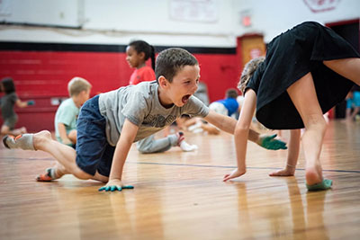 kids having fun crawling on gym floor