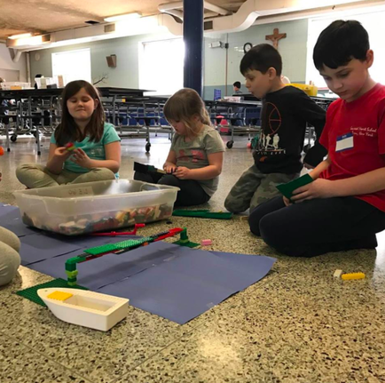 childcare program in Albany: kids working on a creative project together