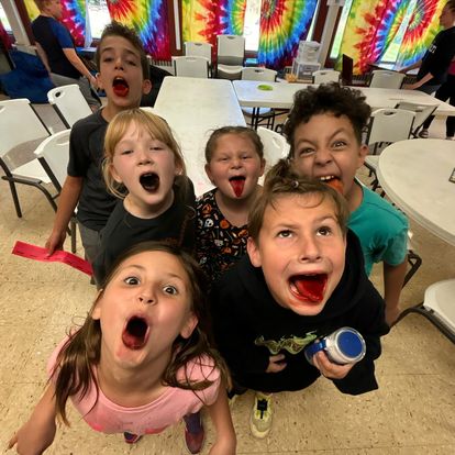 kids showing mouths after eating dark treat