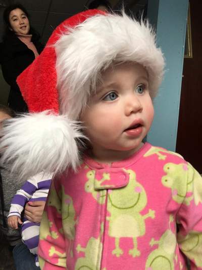 little girl at day care with Santa hat