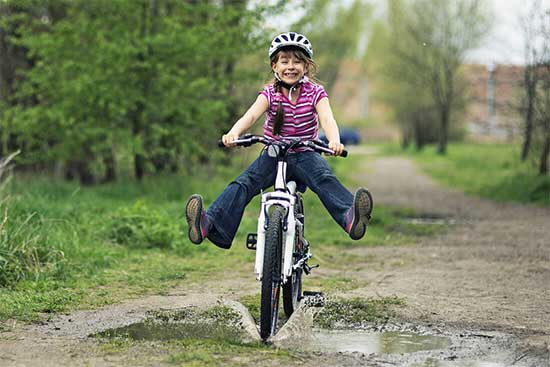 child riding bike down path