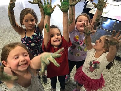 campers show off green paint on their hands
