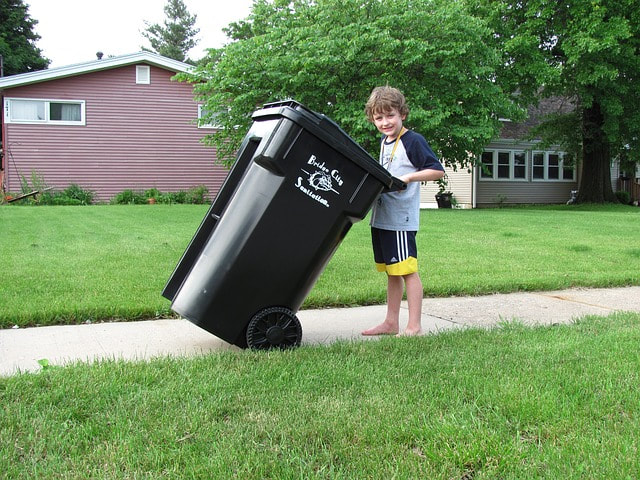 kid doing chore - taking out the trash